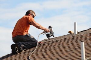 Light-colored residential roof reflecting sunlight above a ventilated attic during summer.
